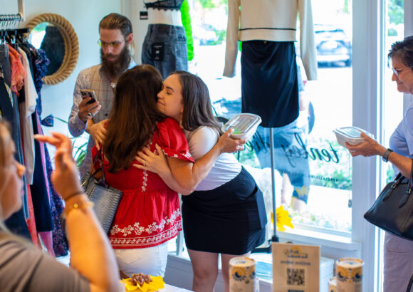 two people hugging at a party